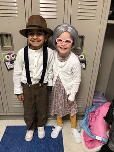 two children standing next to each other in front of lockers wearing glasses and hats