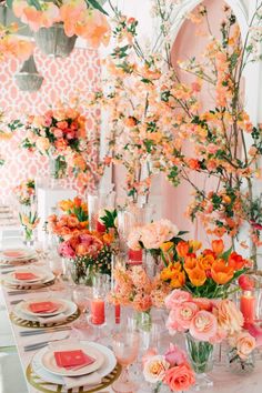 the table is set with flowers, candles and place settings for an elegant dinner party