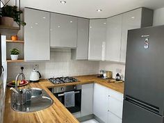 a modern kitchen with stainless steel appliances and wood counter tops