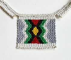 Charming old vintage Native American glass beadwork necklace Length: 1-7/8" Height: 1-5/8" Necklace length: 14-1/2" Good vintage condition with minor wear NOTE: Please bear in mind that, when you purchase vintage , it might not be perfect, but it will be authentic.  No returns will be accepted on vintage items so make sure that you read the description and look at the pictures before committing to a purchase. Please contact me if you have additional questions about the nature and condition of the product. Traditional Beaded Rectangular Necklaces, Traditional Beaded Rectangular Necklace, Traditional Rectangular Beaded Necklace, Ceremonial Beaded Necklaces With Colorful Beads, Traditional Beaded Necklace For Crafting, Traditional Rectangular Jewelry With Colorful Beads, Ceremonial Colorful Beaded Necklaces, Traditional Multicolor Rectangular Necklace, Traditional Beaded Necklaces With Bead Caps