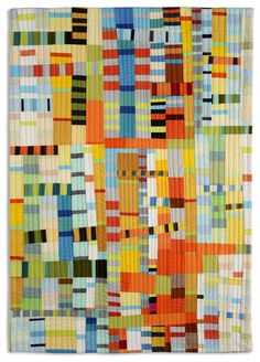 an abstract quilt made with multicolored squares and lines on white background, showing the colors