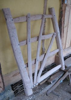 an old wooden chair sitting in front of a yellow wall with wood slats on the floor