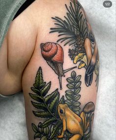 a woman's arm with tattoos on it and some animals in the forest around her