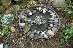 a garden with rocks arranged in the shape of a sundial on top of it