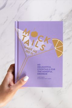 A book is held over a granite countertop. The book is entitled: Mocktails Made Me Do It. The cover is purple with white and yellow accents. Bar Cart Inspo, Dry January, Fruity Drinks, Bad Behavior, Delicious Cocktails, Try Something New, Mocktails, Summer Drinks, Bar Cart