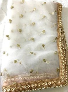 Gold Sharara With Sheer Dupatta For Wedding, Gold Organza Lehenga With Dori Work, Gold Organza Choli With Sheer Dupatta, White Dabka Work Dupatta For Wedding, Gold Embroidered Fabric With Gota Work For Wedding, White Dabka Work Wedding Dupatta, Gold Sharara For Wedding With Gota Work, Gold Choli With Sheer Dupatta In Organza, Diwali Gold Sharara With Sheer Dupatta