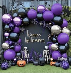 a purple and black halloween wreath with balloons