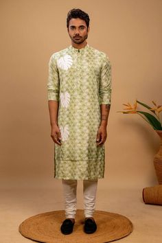 Green geometric print muslin kurta with a double layer design detail and white monsterra leaf appliques sliding down one side of the kurta in descending sizes. Paired with an off white churidar. - Aza Fashions Green Cotton Kurta For Transitional Season, Casual Block Print Kurta For Eid, Transitional Green Cotton Kurta, White Kurta With Block Print Traditional Drape, Cotton Kurta With Ikat Print For Eid, Festive Cotton Kurta With Batik Print, White Chanderi Kurta With Bandhani Print, Cotton Ikat Print Kurta For Eid, Casual Green Block Print Kurta