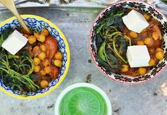 two bowls filled with food sitting on top of a metal tray next to each other