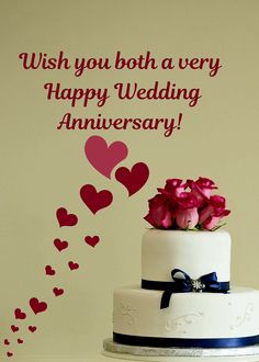 a wedding cake with pink roses and hearts on the wall behind it that says, wish you both a very happy wedding anniversary