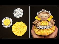 the doll is wearing a yellow dress and has three pieces of fabric around it to make it look like she's holding something in her hands