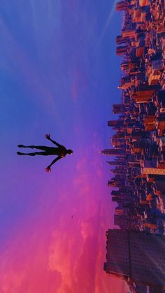 a person is flying through the air in front of a cityscape with tall buildings