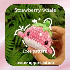 a hand holding a small crocheted toy with the words strawberry whale free pattern and tester appreciation