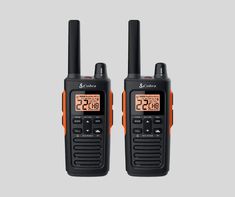 two walkie talkies sitting next to each other on a white background with the same time