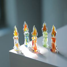 several small glass candles sitting on top of a table