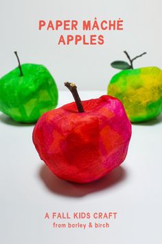 two paper mache apples sitting next to each other on a white surface with the words paper mache apples written below them