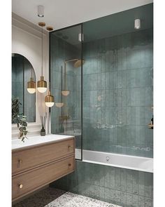 a bathroom with green tile and gold fixtures