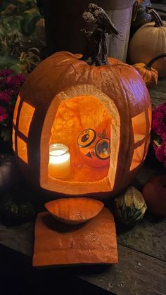 a carved pumpkin sitting on top of a wooden table