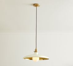 a light fixture hanging from the ceiling in a room with white walls and flooring