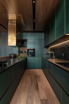 a kitchen with green cabinets and wood floors is seen in this image from the inside