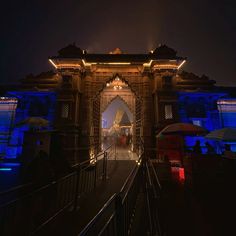 the entrance to an old building lit up at night