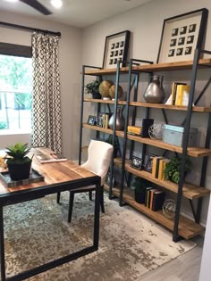 a living room filled with furniture and a book shelf next to a large open window