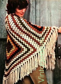 a woman wearing a crocheted shawl with fringes