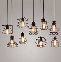 a bunch of lights that are hanging from the ceiling in a room with gray walls