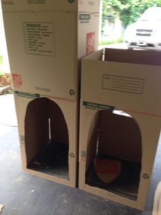 two cardboard pizza boxes sitting on the ground