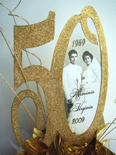 the 50th anniversary cake is decorated with gold ribbons