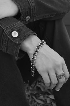 Woman Biker wearing a motorcycle bike chain bracelet Black Metal Jewelry For Biker Events, Biker Style Black Metal Jewelry, Black Biker Style Bracelets For Biker Events, Black Chain Link Jewelry For Streetwear, Black Metal Biker Jewelry, Black Chain Link Bracelet, Classic Black Chain Link Bracelets, Black Link Bracelets In Stainless Steel, Classic Black Bracelets With Silver Chain