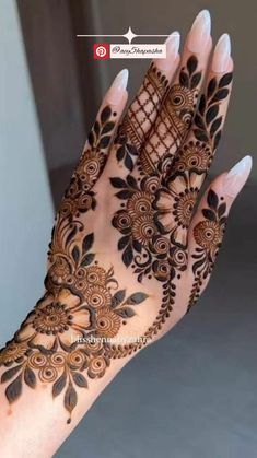 the hand is decorated with henna designs