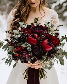 a bride holding her bouquet in the snow