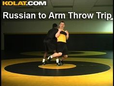 two men in black and yellow shirts are dancing on a floor with the words russian to arm throw trip