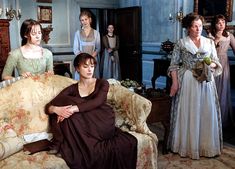 a group of women standing and sitting around a living room