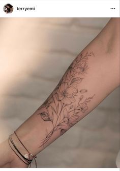 a woman's arm with flowers on it