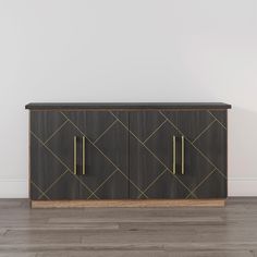 a black and gold sideboard against a white wall with wood flooring in an empty room