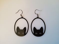 black cat earrings with hoops hanging from them