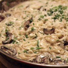 pasta with mushrooms and parmesan cheese in a pan