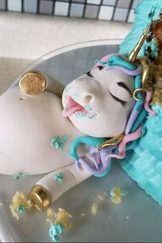 a cake shaped like a unicorn laying on top of a table