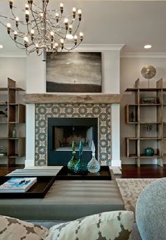 a living room filled with lots of furniture and a chandelier hanging from the ceiling