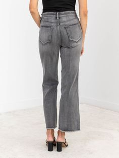 Unleash your inner fashionista with MICA's Dark Grey Super High Rise Wide Leg - featuring a trendy frayed hem, flattering high rise fit, and stretchy fabrication for ultimate comfort and style. Upgrade your wardrobe with these must-have grey wash jeans that boast a wide leg design. Grey Washed Color Wide Leg Opening Stretchy Fabrication High Rise Fit 32% Cotton, 34% Viscose Rayon, 32% Polyester, 2% Spandex. Rise: approx. 11" Inseam: approx. 29" Model is wearing a size 26. Fall Mid-rise Flare Jeans With Frayed Hem, Trendy Bottoms With Unfinished Hem For Fall, Denim Hoodie, Bridal Shower Outfit, Skirt Jumpsuit, Dressy Dresses, Style Upgrade, Viscose Rayon, Mother Denim