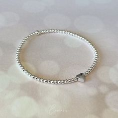 For this bracelet, around 90 high-quality beads are strung together and have a heart in the middle. The bracelet does not require a clasp and can simply be slipped over the wrist. ★ Bracelet length: XS-XL (approx. 15-19 cm) ★ Heart: silver-plated metal ★ Beads: 2.5 mm, 925 silver with tarnish protection made from 80% recycled silver ★ Handmade on Lake Constance in the south of Germany ★ Valuable care tips for every order for long-lasting enjoyment All jewelry is anti-allergic (nickel free). For Silver Beaded Charm Bracelet With Heart Shape, Silver Beaded Heart Charm Bracelet, Silver Beaded Heart-shaped Charm Bracelet, Silver Heart-shaped Beaded Charm Bracelet, Silver Heart Beaded Bracelets For Everyday, Everyday Silver Heart Beaded Bracelets, Everyday Silver Heart Beaded Bracelet, Sterling Silver Heart Beads Bracelets For Everyday, Silver Beaded Heart-shaped Bracelets