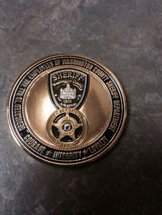 a gold and black badge on a table