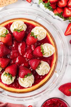 strawberry cheesecake with whipped cream and fresh strawberries on the top, ready to be eaten