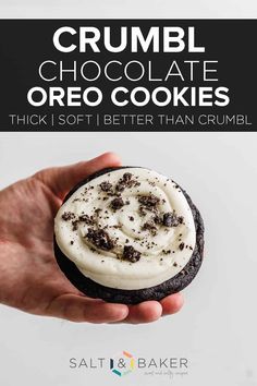 a hand holding a chocolate oreo cookie with white frosting on top and the words crumbl chocolate oreo cookies