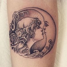 a woman's face with flowers and crescent moon tattoo on her leg, done in black ink