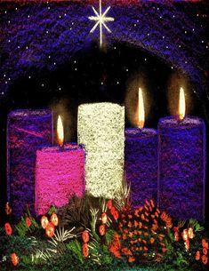 three lit candles sitting on top of a table next to flowers and greenery in front of a star