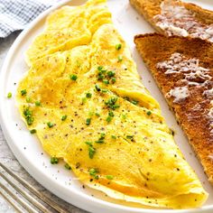 an omelet and toast on a white plate