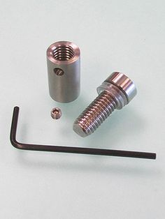 an assortment of metal parts on a white surface with space for the screw to be inserted